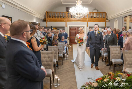 Joanne, the bride, being given away at her Rushton Hall Wedding, Northamptonshire