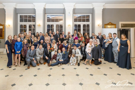 All the family and friends of Joanne and Kevin in a formal wedding group image at the Rushton Hall Wedding, Northamptonshire