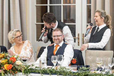 The Singing Waiter Masters sharing a joke with the newly-weds at the top table. Wedding packages in Northamptonshire from John Fox