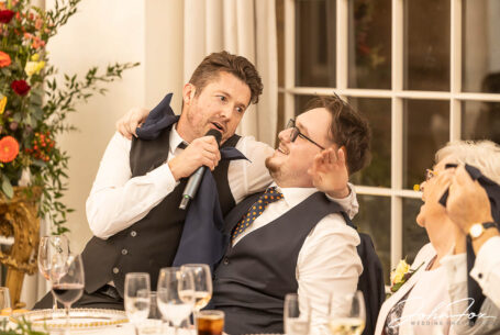 One of the Singing Waiter Masters performing a song to a wedding guest at Joanne and Kevin's Rushton Hall wedding