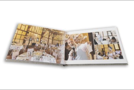 Wedding album open showing page design with images of the speeches at The Tithe Barn, Bedfordshire for Hazel and Chris's wedding