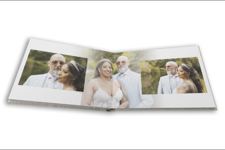 Wedding album open showing page design with images of the bride and groom in the grounds at The Tithe Barn at the Kingfisher Hotel in Bedfordshire