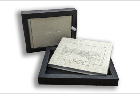 Exclusive Wedding Album image of the presentation box opened with the luxury album inside. Gabrielle and William’s wedding at Kingscote Barn in the Cotswolds.