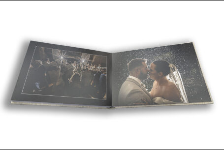 Exclusive Wedding Album images of Gabrielle and William's first dance and a kiss in the evening rain at Kingscote Barn