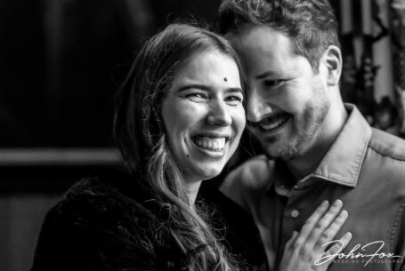 Kilworth House wedding photography Leicestershire by John Fox. A black and white image of Elly and Olly laughing together in one of the stately rooms at the wedding venue.