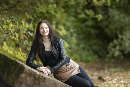 Pre-Wedding Shoot in Staffordshire at Rudyard Lake. Joanne, the bride to be, leaning on a stone wall.