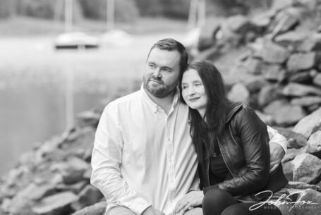 Pre-Wedding Shoot in Staffordshire at Rudyard Lake. Black and white image by John Fox of Joanne and James looking out across the lake.