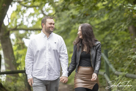 Pre-Wedding Shoot in Staffordshire at Rudyard Lake. Joanne and James looking lovingly at each other while walking along the lake.