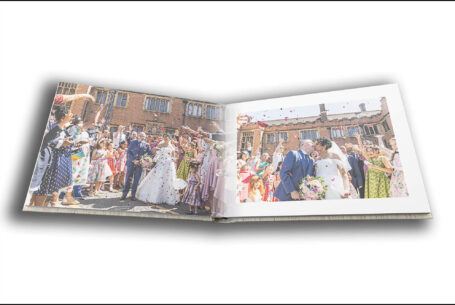 Wedding album by John Fox opened at a page showing images of confetti being thrown at Nisha and Marco's wedding in Putteridge Bury, Bedfordshire
