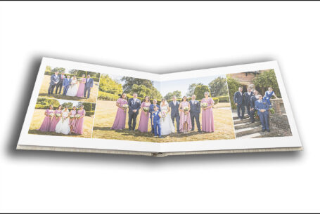 Wedding album by John Fox opened at a page showing images of the happy couple and guests in the grounds at the wedding venue in Putteridge Bury, Bedfordshire