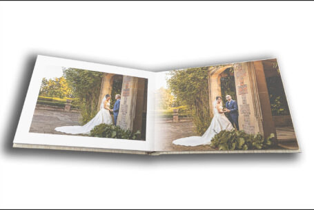 Wedding album by John Fox opened at a page showing images of the happy couple in the grounds at the wedding venue in Putteridge Bury, Bedfordshire