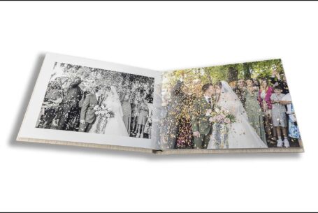 Parents Wedding Album opened at images of Sarah and Lewis being showered with confetti. Photo by John Fox Wedding Photography
