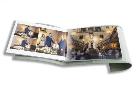 Nicole and Nicholas’s Wedding Album opened at pages showing images of their ceremony on the staircase at Ashridge House