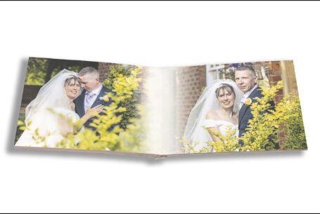 Emily and Jason outside The Holiday Inn Milton Keynes in Buckinghamshire in glorious sunshine. Images from their beautifully-crafted wedding album from John Fox Wedding Photography.