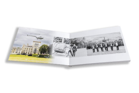 Zoe and Josh’s Wedding Album opened at the pages showcasing the Groom's arrival by helicopter. Ashridge House, Hertfordshire wedding photographer
