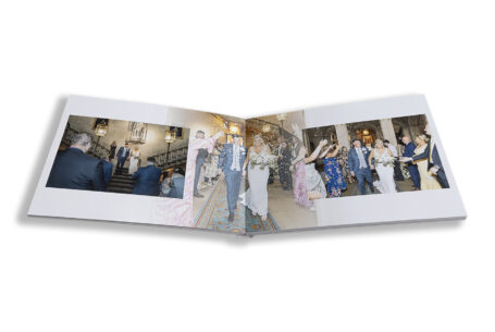 Zoe and Josh’s Wedding Album opened at images of the ceremony on the stairs at Ashridge House, Hertfordshire.