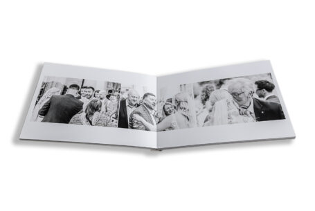 Zoe and Josh’s Wedding Album opened at images of the guests congratulating the newlyweds at Ashridge House, Hertfordshire.