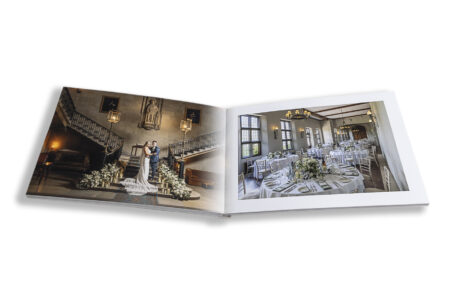 Zoe and Josh’s Wedding Album opened at images of the newlyweds on the staircase at Ashridge House, Hertfordshire.