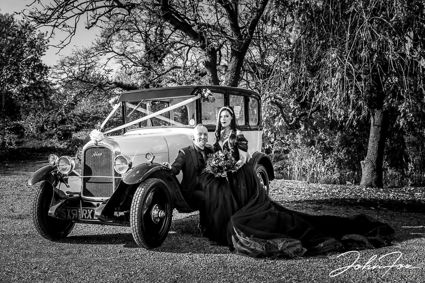 Louise and Jason next to their vintage wedding car at their Moreteyne Manor wedding. John Fox Wedding Photography covering Bedfordshire and beyond.