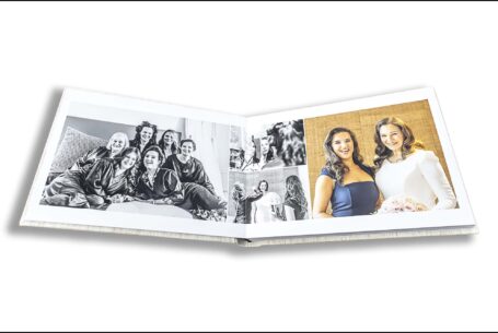 Wedding album open showing page design of the bridal preparations. London Wedding Photography by John Fox.