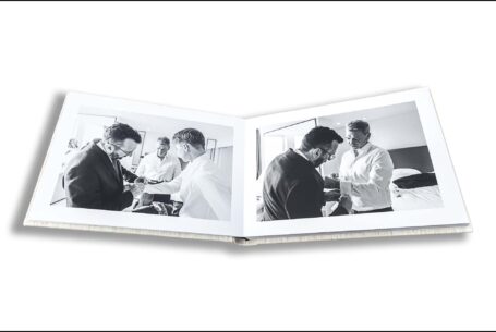 Amanda and Alex’s wedding album open showing images of the groom and groomsmen. London Wedding Photography