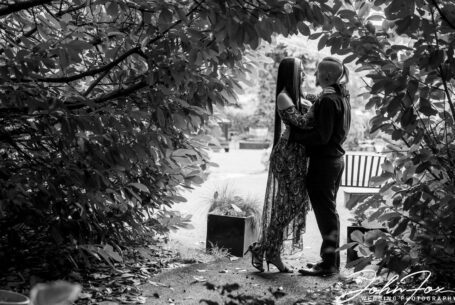 Louise and Jason at Moreteyne Manor framed by trees in the venue's grounds in Bedfordshire.
