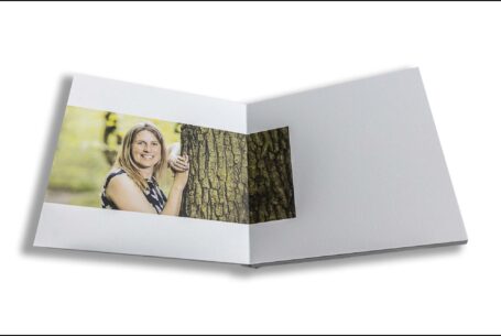 Emily and Jason's Wedding Guest Book showing an image of the bride-to-be leaning against a tree in a bluebell wood in Northamptonshire