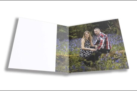 Emily and Jason's Wedding Guest Book showing an image of the couple sitting in a Northamptonshire wood. Photo by John Fox.