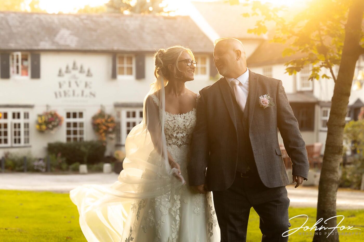 Lynn and Ian outside The Five Bells Pub in Bedfordshire on their wedding day with sunlight streaming down on the happy couple. Wedding Photographer in Leighton Buzzard, Bedfordshire