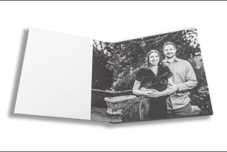 Elly and Olly’s pre-wedding shoot guest book opened at a black and white image by John Fox - Wedding photography at Kilworth House in Leicestershire