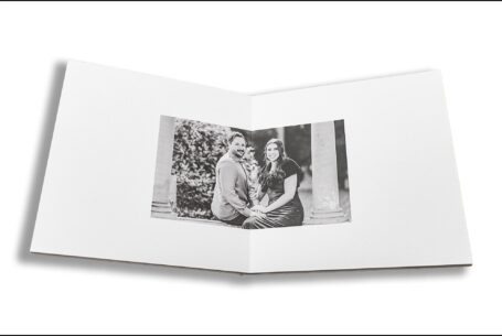 Elly and Olly’s pre-wedding shoot guest book opened at a black and white image of the happy couple at Kilworth House in Leicestershire