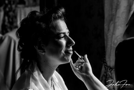 Eleanor's bridal preparations at Kilworth House in Leicester. Black and white close up of the bride having her make-up applied.