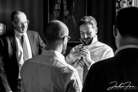 The groom's preparations at Kilworth House in Leicester. Oliver and his entourage getting ready. Image by John Fox Wedding Photography.
