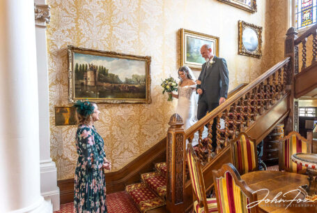 Eleanor and her father descending the stairs at Kilworth House, making their way to the ceremony.