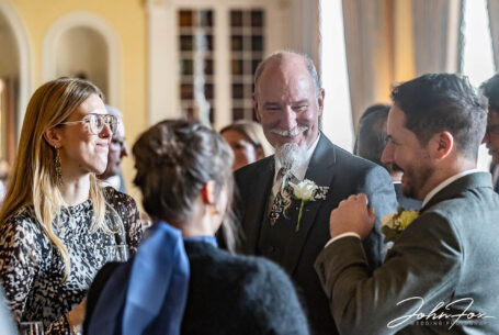 The groom, Oliver, chatting with his in-laws after the wedding ceremony at Kilworth House. Photo by John Fox Wedding Photography