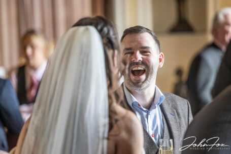 The bride and one of her wedding guests chatting after the Kilworth House wedding ceremony in Leicester