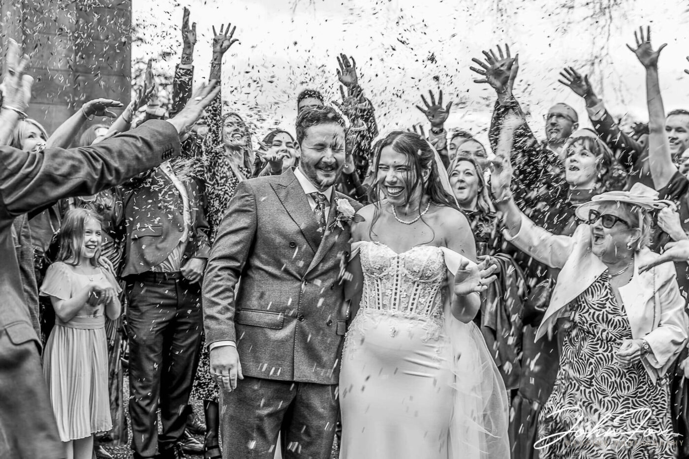 Eleanor and Oliver at Kilworth House Hotel with confetti being thrown over the newlyweds. Wedding Photographer at Kilworth House in Leicester.