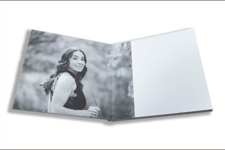 Wedding guest book with images from the pre-wedding shoot in Buckinghamshire. Image of Figan, the bride-to-be turning to the camera in a country setting.