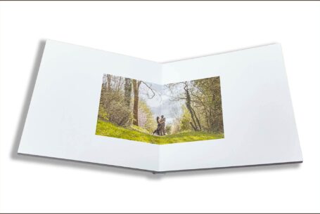 Wedding Guest Book Image of Phil and Figan holding each other in a woodland setting in Buckinghamshire.