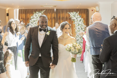 Figan and Philip’s Wedding ceremony walking down the aisle at Abbey Hill Golf Centre, Milton Keynes, Buckinghamshire