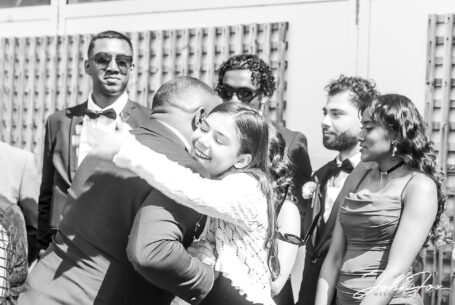 Congratulations after the wedding. Philip and wedding guest hugging each other.