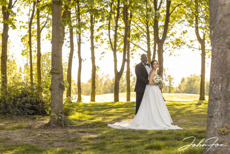 Figan and Philip in the sunlit woodland grounds of Abbey Hill Golf Centre on their special day.