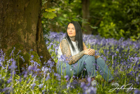 Wedding Photographer in Rugby, Warwickshire capturing a wonderful scene of sitting amongst the bluebells for a pre-wedding shoot