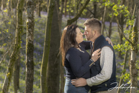 Pre-wedding image in Leicestershire woodland of the bride and groom to be, Paige and Reece, embracing with nature all around them. Wedding Photographer covering Leicestershire, John Fox.