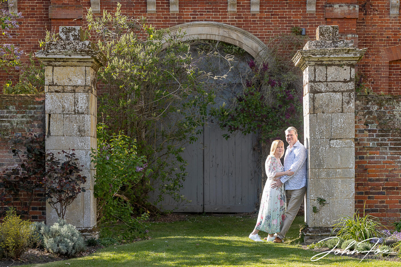 Jayne and Craig outside an overgrown entrance on their Pre-Wedding Shoot at Chicheley Hall. Wedding Photographer in Buckinghamshire