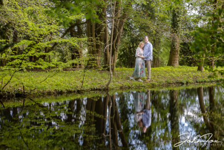 Pre-wedding shoot at Chicheley Hall. The couple-to-be reflected in a pond in the gardens of the venue. Wedding Photographer in Buckinghamshire, John Fox.