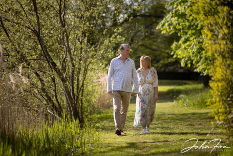 Pre-wedding shoot at Chicheley Hall with the couple in the gardens of the venue walking together and chatting. Wedding Photographer in Buckinghamshire, John Fox.