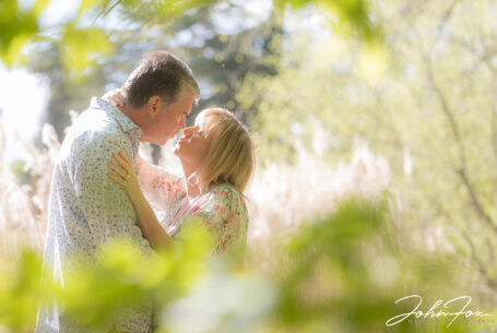 Pre-wedding image at Chicheley Hall with the happy couple about to kiss in the gardens of the venue. Wedding Photographer in Buckinghamshire, John Fox.
