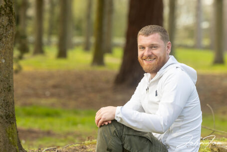 Pre-wedding shoot at Tree Cathedral in Milton Keynes - the groom, Lewis, sitting among the trees