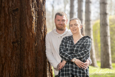 Jade and Lewis on their Pre-wedding Shoot in Milton Keynes holding hands and smiling warmly at the camera